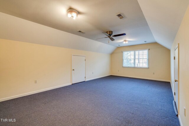 2017 Springfield Ave, Kingsport, TN 37664 - additional living space featuring dark carpet, visible vents, vaulted ceiling, and a ceiling fan