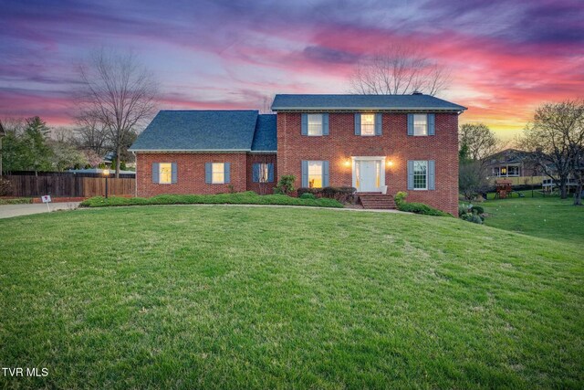 2017 Springfield Ave, Kingsport, TN 37664 - colonial house with a front yard, fence, and brick siding