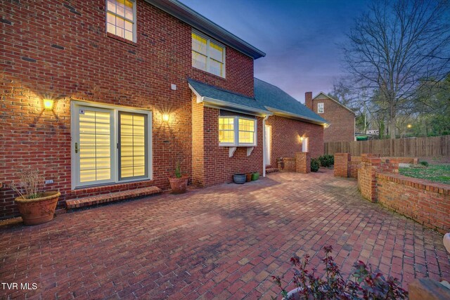 2017 Springfield Ave, Kingsport, TN 37664 - rear view of property with a patio, brick siding, fence, and a shingled roof