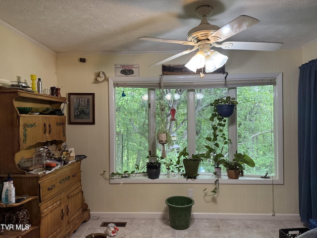 649 Sugar Run Rd, Jonesville, VA 24263 - dining space featuring a textured ceiling, baseboards, a ceiling fan, healthy amount of natural light, and ornamental molding