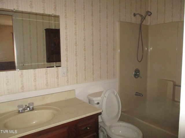 145 Rock City Rd, Kingsport, TN 37664 - bathroom with wallpapered walls, toilet, vanity, and wainscoting