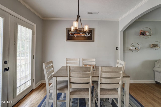 232 Meadow Dr, Bristol, TN 37620 - dining room featuring wood finished floors, crown molding, arched walkways, and a chandelier