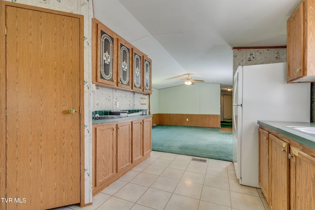120 Bear Hollow Rd, Bristol, TN 37620 - kitchen with ceiling fan, wainscoting, lofted ceiling, glass insert cabinets, and light carpet