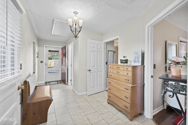 4245 Maplewood St, Kingsport, TN 37660 - entrance foyer with baseboards, a textured ceiling, a notable chandelier, and light tile patterned floors