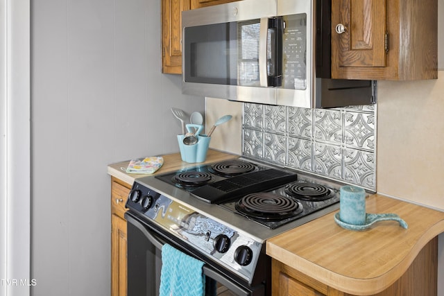 4245 Maplewood St, Kingsport, TN 37660 - kitchen with light countertops, brown cabinetry, tasteful backsplash, and appliances with stainless steel finishes