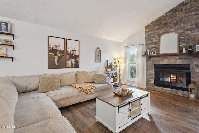 living area featuring high vaulted ceiling, a textured ceiling, a fireplace, and dark wood finished floors