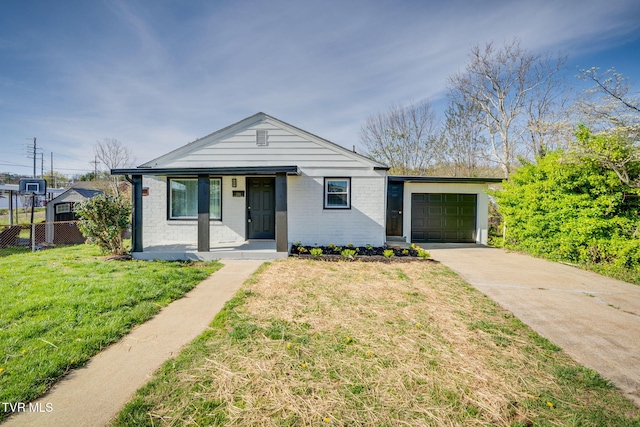 533 Sequoyah Dr, Kingsport, TN 37660 - bungalow with concrete driveway, fence, an attached garage, a front lawn, and a porch