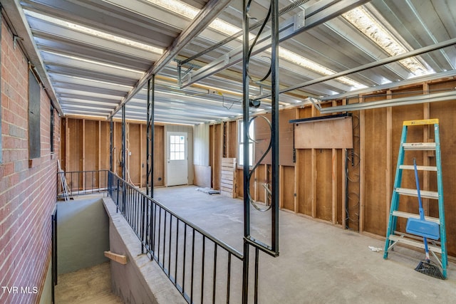 533 Sequoyah Dr, Kingsport, TN 37660 - interior space featuring unfinished concrete flooring and brick wall