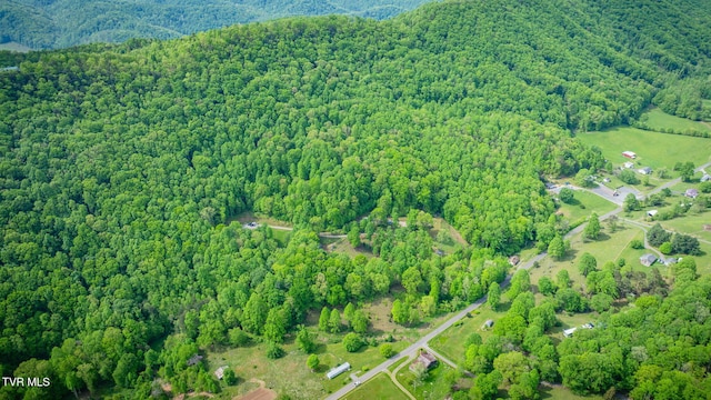 drone / aerial view featuring a forest view