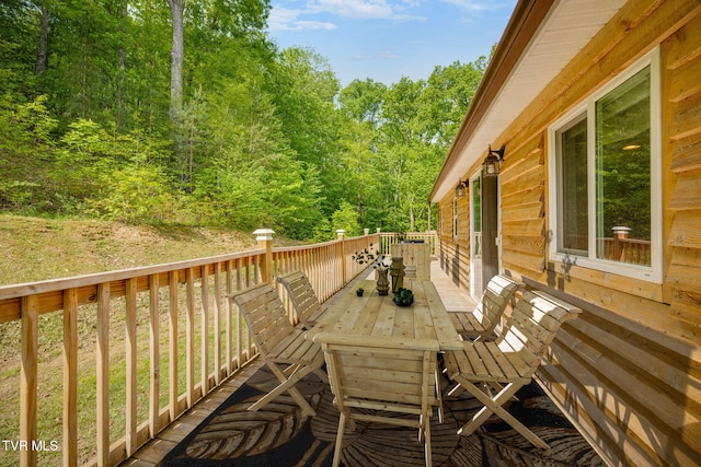 wooden terrace featuring outdoor dining space