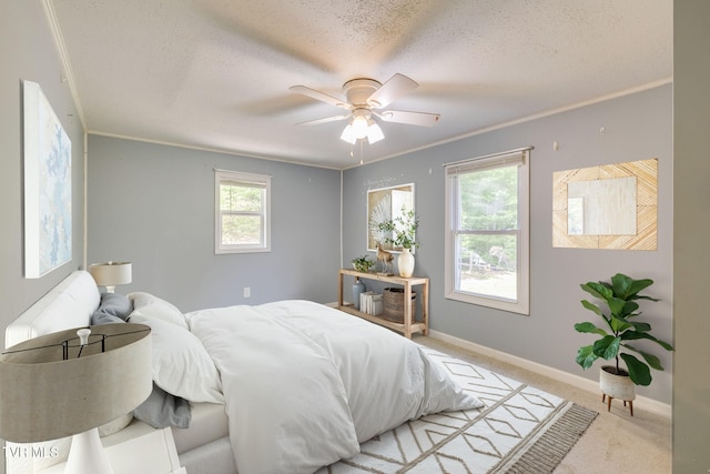 carpeted bedroom with baseboards, ceiling fan, and a textured ceiling