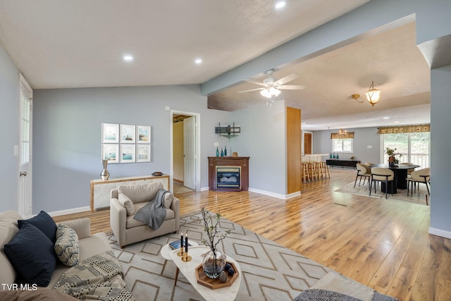 living area featuring recessed lighting, lofted ceiling with beams, light wood finished floors, and a ceiling fan