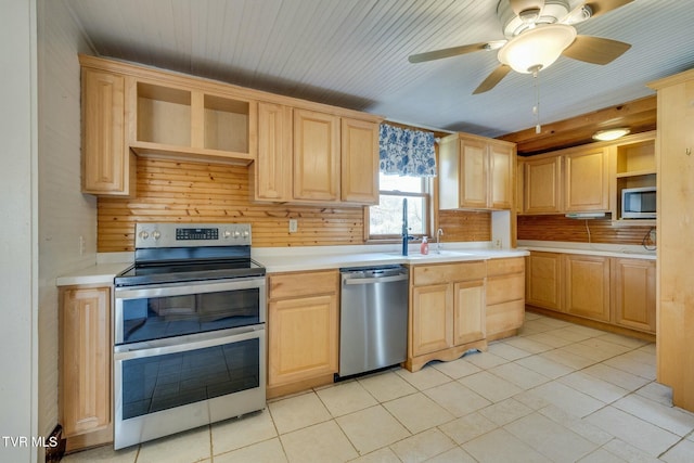 kitchen featuring open shelves, light countertops, light brown cabinetry, and stainless steel appliances