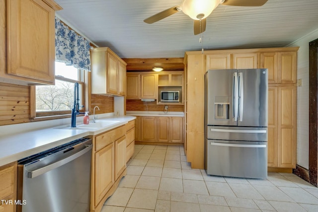 kitchen featuring light countertops, light brown cabinets, light tile patterned floors, and stainless steel appliances