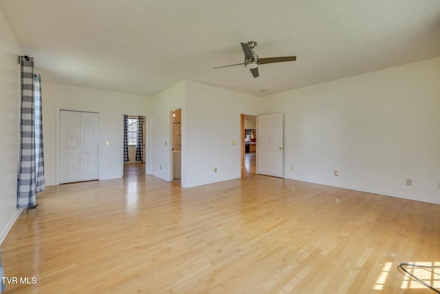 unfurnished room featuring ceiling fan and light wood-type flooring