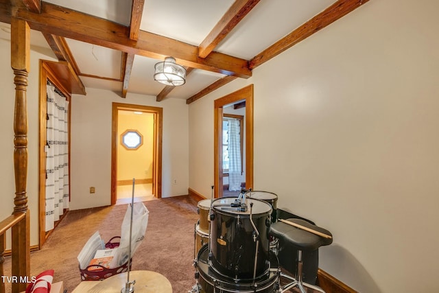 entrance foyer featuring carpet flooring, beam ceiling, and baseboards