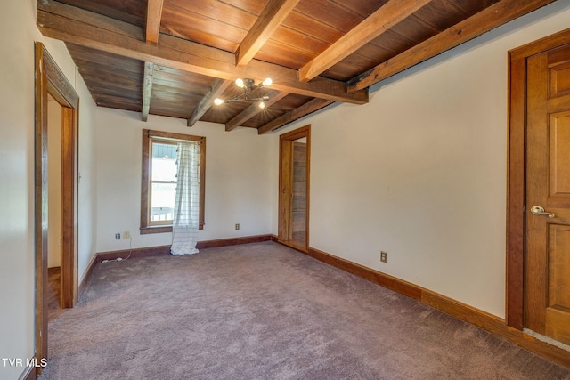 unfurnished bedroom featuring baseboards, carpet, wood ceiling, and beam ceiling