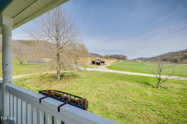 view of yard featuring a balcony and a rural view