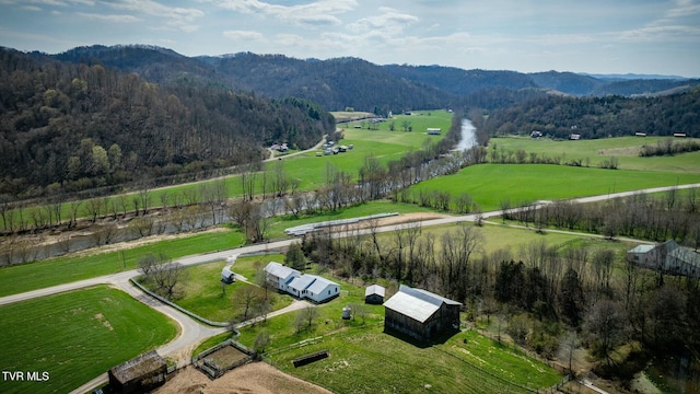 aerial view with a wooded view, a mountain view, and a rural view