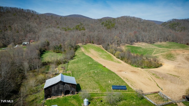 aerial view featuring a mountain view, a view of trees, and a rural view