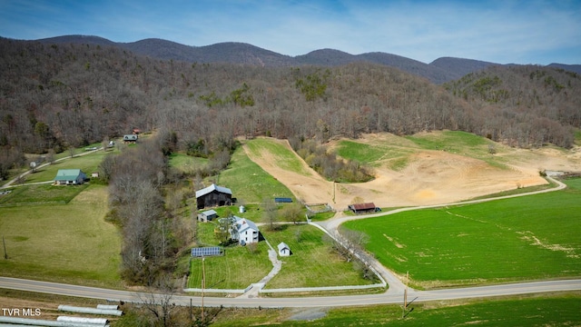 aerial view with a wooded view and a mountain view