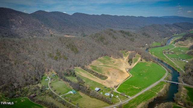 drone / aerial view featuring a water and mountain view