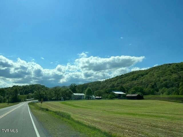 view of road with a wooded view