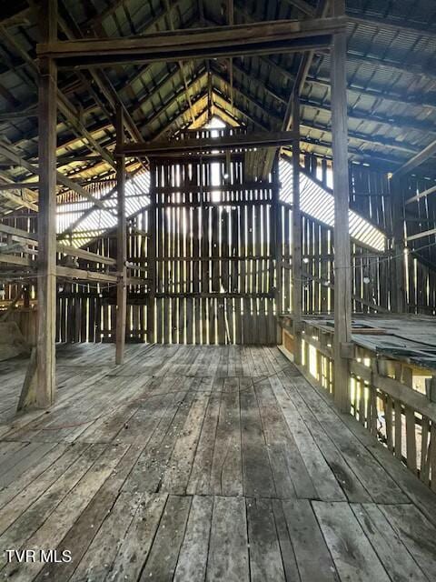 miscellaneous room featuring hardwood / wood-style floors and vaulted ceiling