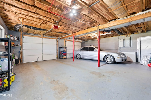 garage with electric panel and a garage door opener