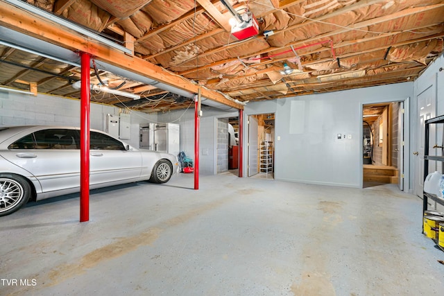 garage with a garage door opener and electric panel