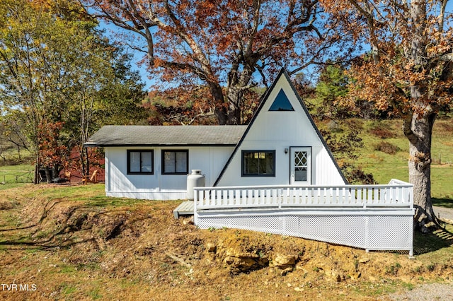 a-frame style home with roof with shingles
