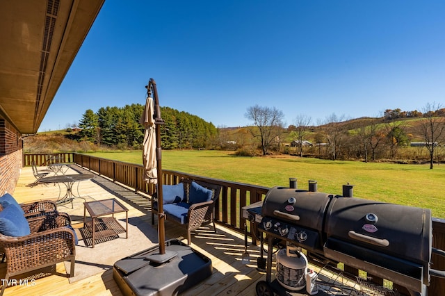 wooden deck featuring a yard and grilling area