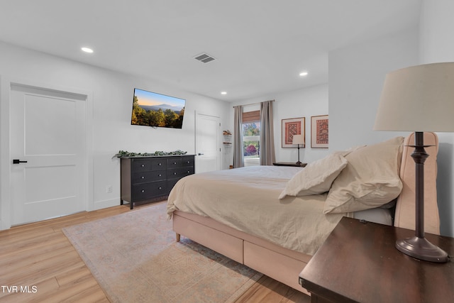 bedroom featuring visible vents, recessed lighting, and wood finished floors