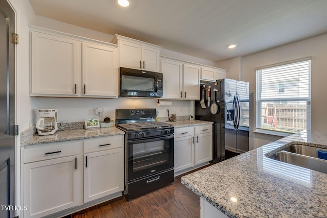 1205 Stamp Lodge Rd, Kingsport, TN 37660 - kitchen with white cabinetry, recessed lighting, dark wood-type flooring, light stone counters, and black appliances