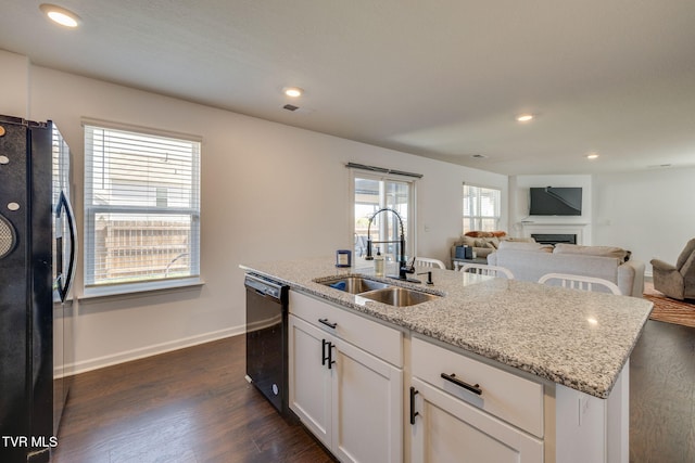 1205 Stamp Lodge Rd, Kingsport, TN 37660 - kitchen featuring light stone counters, a sink, dark wood finished floors, open floor plan, and black appliances