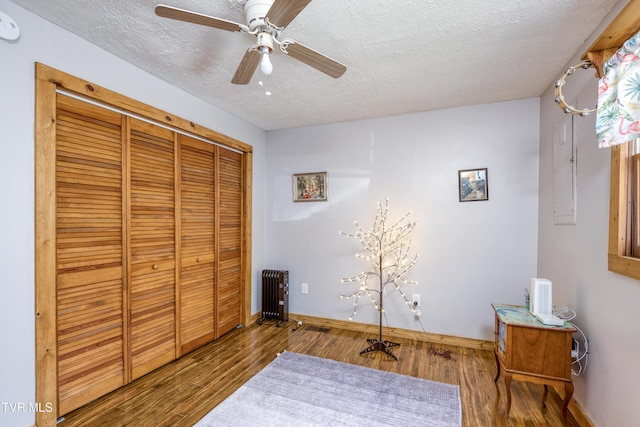 23324 Denton Valley Rd, Abingdon, VA 24211 - bedroom with a closet, wood finished floors, radiator heating unit, a textured ceiling, and ceiling fan