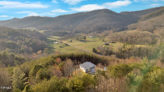 aerial view featuring a wooded view, a mountain view, and a rural view