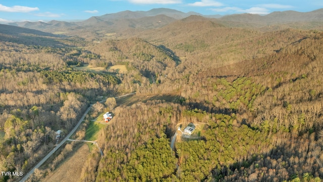 aerial view with a wooded view and a mountain view