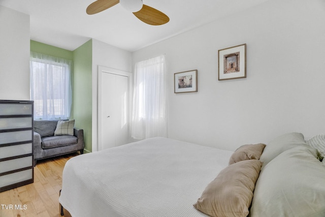 bedroom with light wood-style floors and ceiling fan