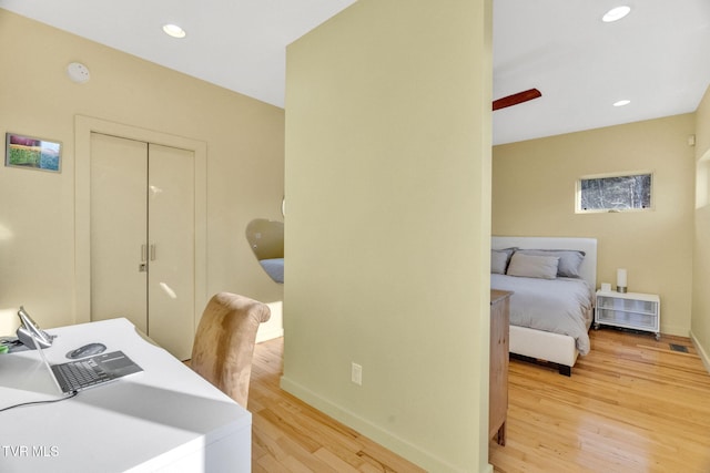 office featuring light wood finished floors, baseboards, and recessed lighting
