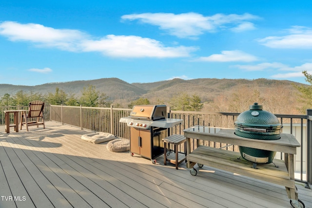 wooden deck featuring area for grilling and a mountain view