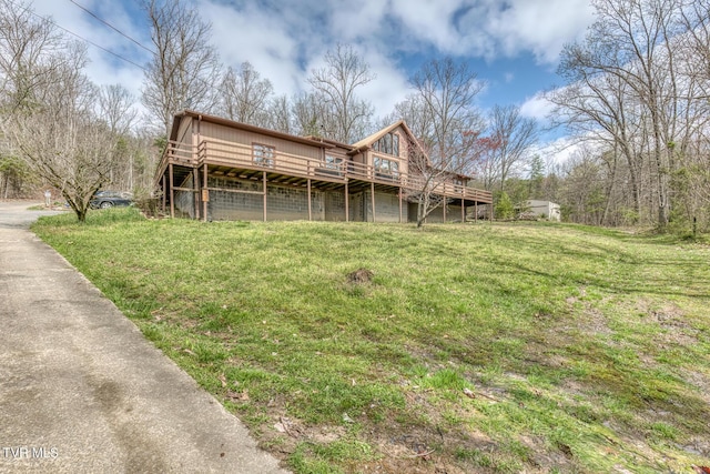 back of house with a lawn and a deck