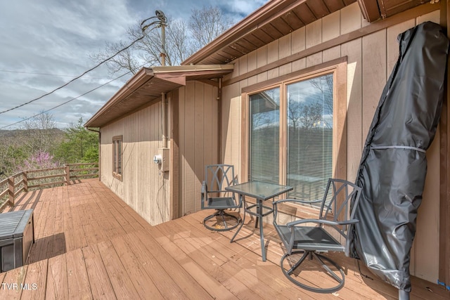 wooden terrace featuring outdoor dining space