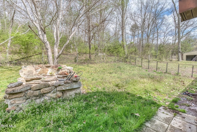 view of yard with a garage and fence