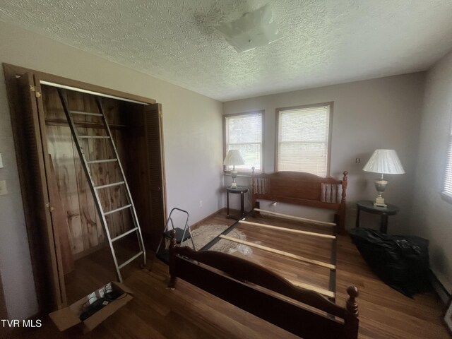 4235 Kiser Rd, Coeburn, VA 24230 - bedroom with wood finished floors, a textured ceiling, and baseboards