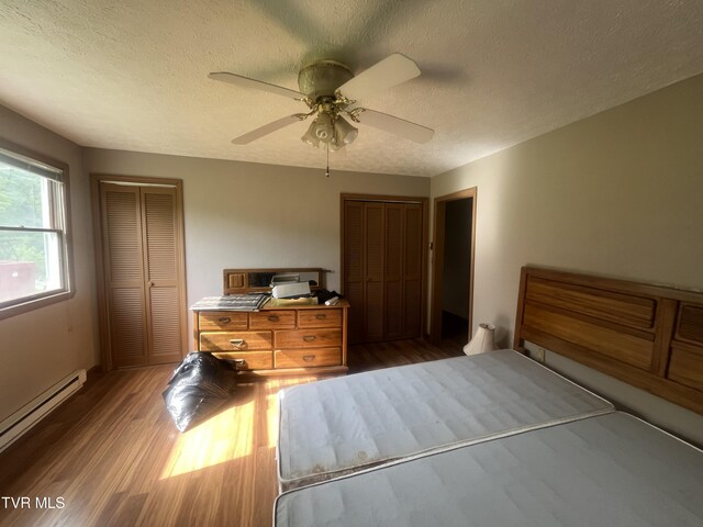 4235 Kiser Rd, Coeburn, VA 24230 - bedroom with baseboard heating, wood finished floors, a textured ceiling, and ceiling fan