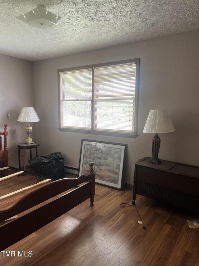 4235 Kiser Rd, Coeburn, VA 24230 - bedroom featuring wood finished floors, a textured ceiling, and a baseboard heating unit