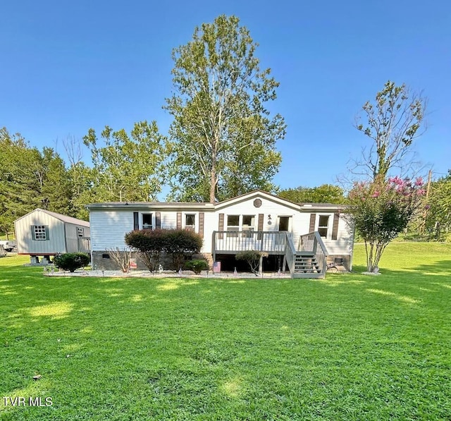 rear view of property with a lawn, a wooden deck, and crawl space