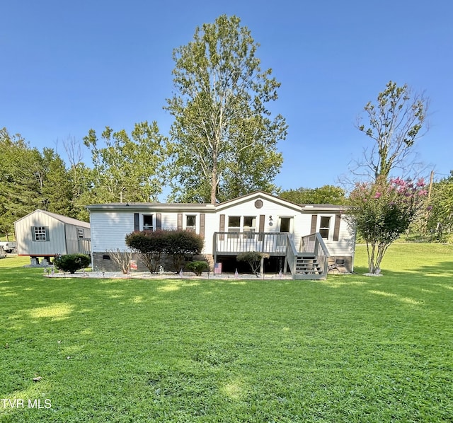 back of house featuring crawl space, a wooden deck, and a lawn