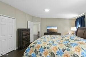 bedroom with dark wood-type flooring